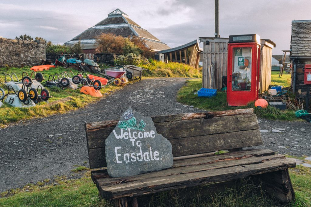 Colourful wheelbarrows and the Welcome to Easdale Island sign 