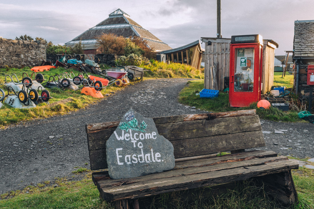 Colourful wheelbarrows and the Welcome to Easdale Island sign